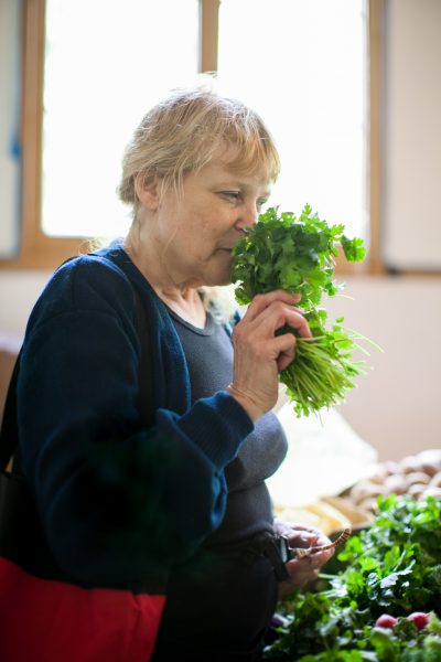 woman smelling cilantro